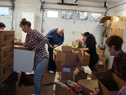 A group of people packing boxes

Description automatically generated